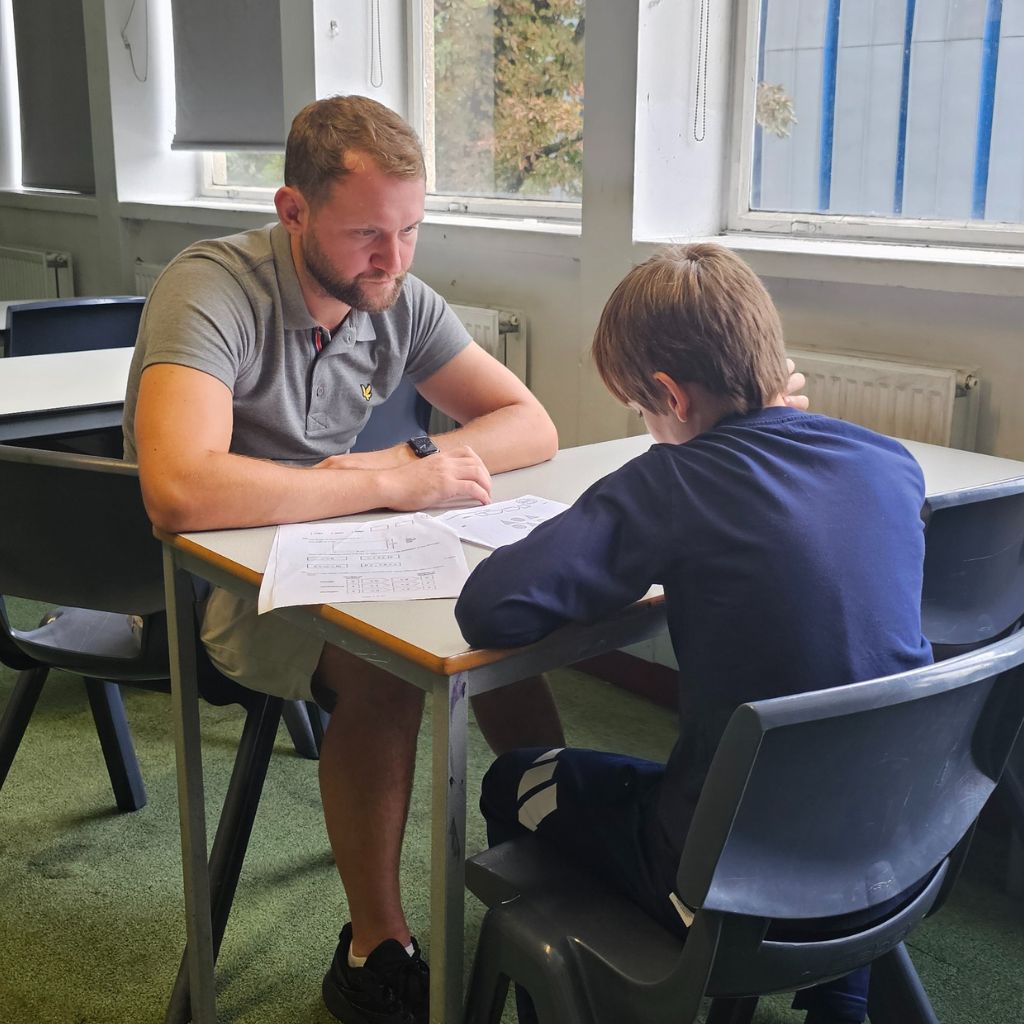 Young children receiving one-to-one guidance during Elite School Tutors exam prep session